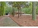 A brick ranch-style home surrounded by trees and a long circular driveway leading to the garage at 263 Weldon Rd, Palmetto, GA 30268