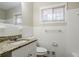 Updated bathroom with granite countertop and white tile at 3743 Turner Heights Dr, Decatur, GA 30032