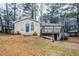 Tan house with blue door, deck, and landscaped yard at 3743 Turner Heights Dr, Decatur, GA 30032