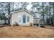 Tan house with blue door and deck in wooded area at 3743 Turner Heights Dr, Decatur, GA 30032
