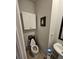 Small half bathroom features a white vanity, toilet, and gray walls at 2502 Polaris Sw Way, Atlanta, GA 30331