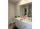 Bright bathroom featuring a double vanity with white cabinets and a framed mirror reflecting the shower at 2502 Polaris Sw Way, Atlanta, GA 30331