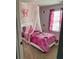 Whimsical bedroom with pink decor, custom wall art, and a canopy bed at 2502 Polaris Sw Way, Atlanta, GA 30331