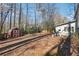 Spacious backyard with mature trees, a shed with criss-cross design, and plenty of room for outdoor activities at 190 Hembree Forest Cir, Roswell, GA 30076