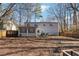 Large backyard with a two-story home, a patio, and mature trees providing plenty of shade at 190 Hembree Forest Cir, Roswell, GA 30076