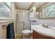 Comfortable bathroom featuring a shower with glass door, toilet, and a sink at 190 Hembree Forest Cir, Roswell, GA 30076