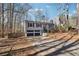 Split-level home features two-car garage and driveway leading up to the home with mature trees at 190 Hembree Forest Cir, Roswell, GA 30076