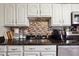 Classic kitchen features granite countertops, stainless steel appliances, and white cabinets at 190 Hembree Forest Cir, Roswell, GA 30076