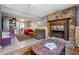 Cozy living room with stone fireplace, sliding glass doors, tile floor, and comfortable furniture at 190 Hembree Forest Cir, Roswell, GA 30076