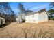 Back exterior view of home with a screened in patio and steps down to the yard at 4807 Highway 212, Covington, GA 30016