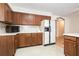 Cozy kitchen features wood cabinetry, white appliances, tile backsplash, and ample counter space at 4807 Highway 212, Covington, GA 30016