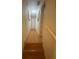 Light-filled hallway with wood flooring and access to upper level at 1129 Realm Ln, Lawrenceville, GA 30044