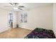 This bright room has laminate floors, a ceiling fan, a large window, and a view to the bathroom at 65 Bridge Dr, Douglasville, GA 30134