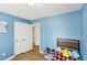 Bedroom with wood floors, blue walls, and ample closet space at 65 Bridge Dr, Douglasville, GA 30134