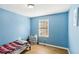 Comfortable bedroom featuring light blue walls, wood floors, and natural light at 65 Bridge Dr, Douglasville, GA 30134