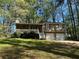 Charming home featuring a front porch, two-car garage, and manicured lawn at 65 Bridge Dr, Douglasville, GA 30134