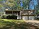 Inviting exterior with front porch, two-car garage, and well-maintained lawn and landscaping at 65 Bridge Dr, Douglasville, GA 30134