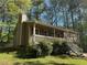 Charming exterior with a porch, red shutters, and well-maintained landscaping at 65 Bridge Dr, Douglasville, GA 30134