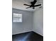 Another bright bedroom with dark hardwood floors and ceiling fan at 6650 Baldwin Ct, Riverdale, GA 30274