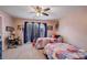 Comfortable bedroom with carpet, ceiling fan, two twin beds with colorful patchwork quilts and a desk at 945 Ashebrooke Ne Trce, Marietta, GA 30068