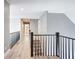 Bright upstairs hallway with hardwood floors, black metal banister, and open sightlines at 945 Ashebrooke Ne Trce, Marietta, GA 30068