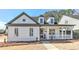 All-white charming house with gray accents, a front porch, and a well-manicured lawn at 102 Chestnut Dr, Canton, GA 30114