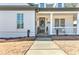 Inviting front porch with white columns and a black front door at 102 Chestnut Dr, Canton, GA 30114