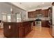 Modern kitchen with dark wood cabinets, granite countertops, and stainless steel appliances at 102 Chestnut Dr, Canton, GA 30114