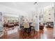 Bright dining area with hardwood floors and a view into the living room at 140 Lost Forest Dr, Mcdonough, GA 30252