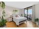 Bright bedroom featuring a walkout balcony, hardwood floors and lots of plants at 3481 Ne Lakeside Dr # 1508, Atlanta, GA 30326