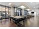 Community game room with a pool table, seating areas, and natural light at 3481 Ne Lakeside Dr # 1508, Atlanta, GA 30326