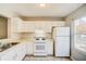 White kitchen with appliances and double sink at 3614 Main Station Sw Dr, Marietta, GA 30008