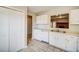Kitchen boasts white cabinets and a view into the living area at 3614 Main Station Sw Dr, Marietta, GA 30008