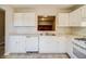 White kitchen features ample counter space and cabinets at 3614 Main Station Sw Dr, Marietta, GA 30008