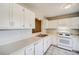 White kitchen cabinets, appliances, and tile floor at 3614 Main Station Sw Dr, Marietta, GA 30008