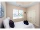 Charming bedroom with a single bed, large window, and neutral decor at 1595 Bluestone Dr, Cumming, GA 30041