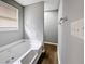 Bathroom with soaking tub and vinyl flooring at 165 Riverbend Dr, Covington, GA 30014