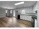 Bright kitchen with white cabinets and vinyl flooring at 165 Riverbend Dr, Covington, GA 30014