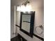 Bathroom vanity with black countertop and mirror at 1970 Wells Sw Dr, Atlanta, GA 30311