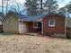 Tan and brick ranch house with a large backyard at 1970 Wells Sw Dr, Atlanta, GA 30311