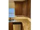 Granite countertops and wood cabinets in the kitchen at 1970 Wells Sw Dr, Atlanta, GA 30311