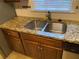 Double sink with granite countertop in the kitchen at 1970 Wells Sw Dr, Atlanta, GA 30311