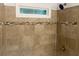 Clean shower with tile surround and small window at 1970 Wells Sw Dr, Atlanta, GA 30311