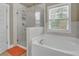 Bathroom with soaking tub, walk-in shower, and marble tile at 2652 Tilson Rd, Decatur, GA 30032