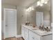 Double vanity bathroom with marble countertop and large mirror at 2652 Tilson Rd, Decatur, GA 30032