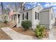 Side view of a charming single-story home with gray siding, black shutters, an inviting front porch, and sidewalk at 189 Parkview Se Dr, Marietta, GA 30060