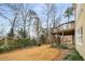 Lush backyard with a multi-tiered deck, and mature trees surrounding the property at 2290 Spencers Way, Stone Mountain, GA 30087