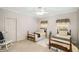This bedroom has carpet and two twin beds under windows with vintage floral valances at 2290 Spencers Way, Stone Mountain, GA 30087