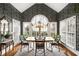 The breakfast nook has wallpaper, large windows, a chandelier, and seating for four at 2290 Spencers Way, Stone Mountain, GA 30087