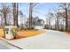 An exterior view of a home showing a long driveway that leads to a three car garage at 2290 Spencers Way, Stone Mountain, GA 30087